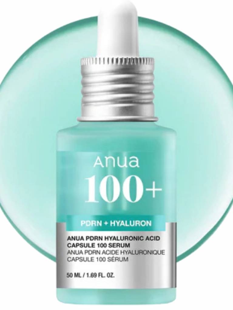 Anua 100+ serum bottle with dropper on a light green background