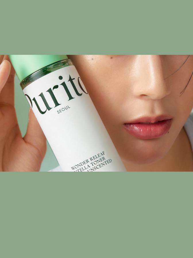 Person holding a Purito skincare product with a green background