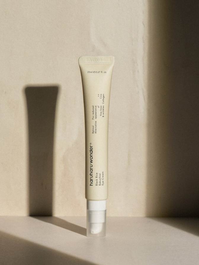 Tube of skincare product on a beige background
