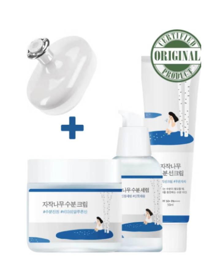 Set of skincare products with a bottle, cream, and lotion on a white background