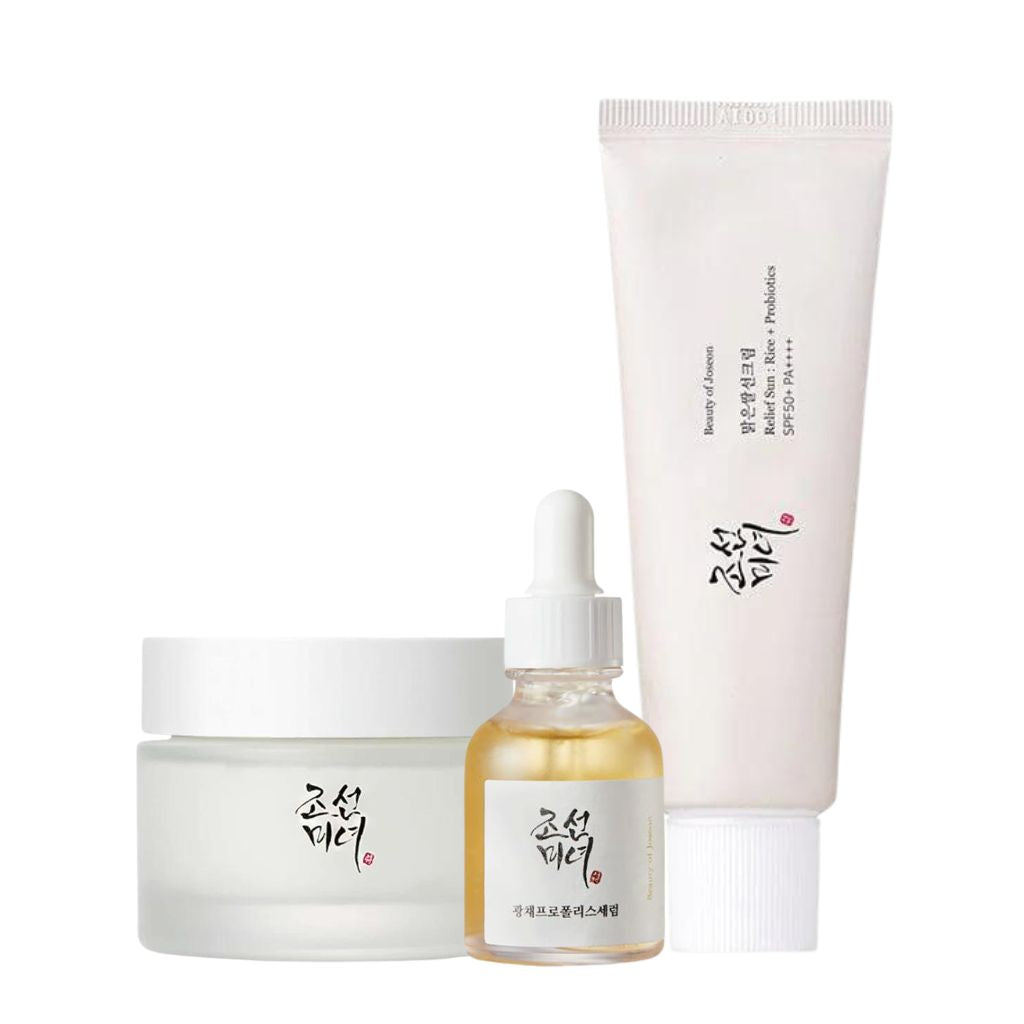 Set of skincare products including a jar, bottle, and tube on a white background